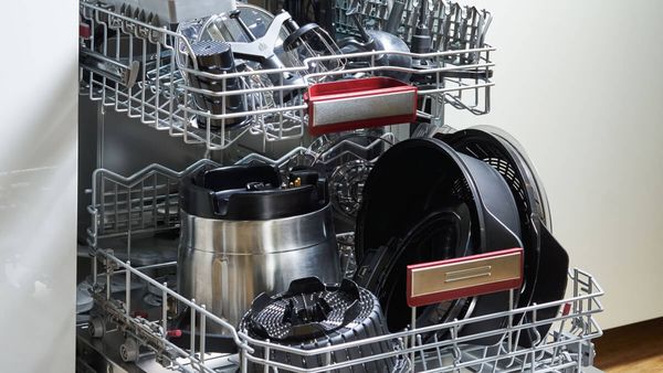 Open dishwasher with all the Cookit equipment.