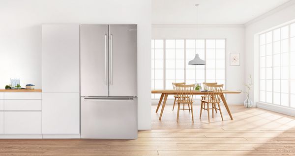 Large open fridge in light kitchen design 