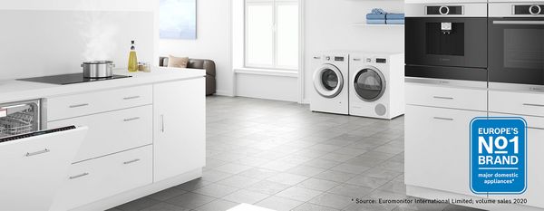 White spacious kitchen with numerous appliances and Europe's No1 logo in corner