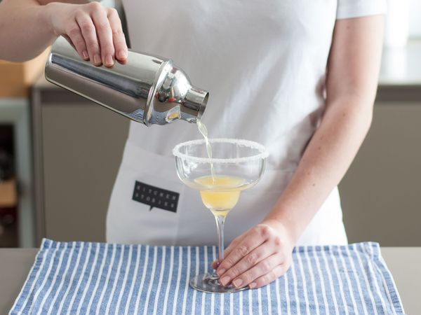 Pouring mixed drink into a martini glass