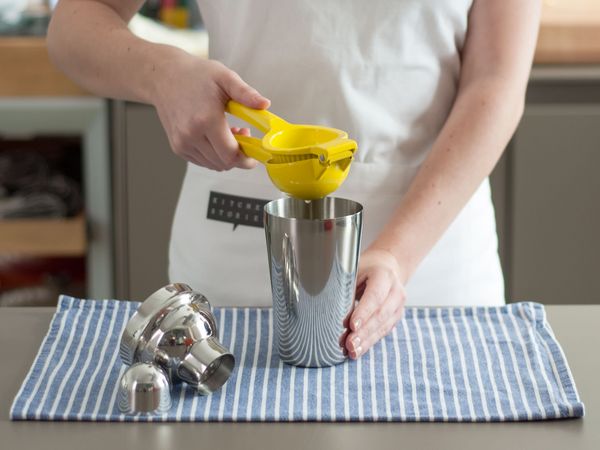 Squeezing lemon into a shaker cup