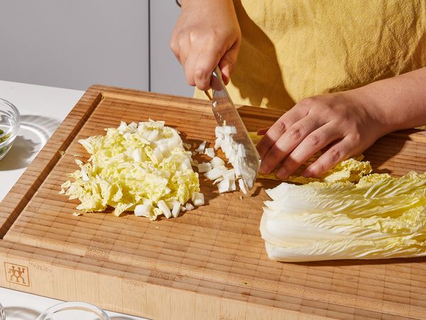 Mincing cabbage on a cutting board