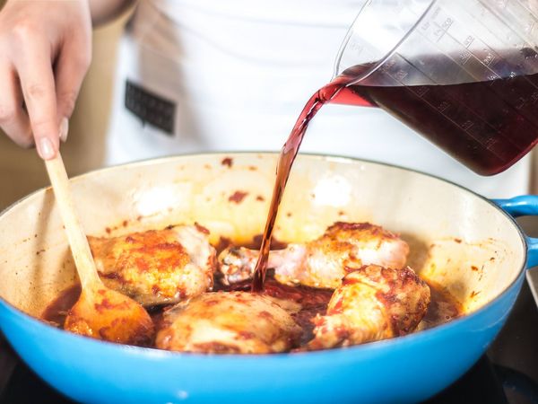 Adding red wine to the pan