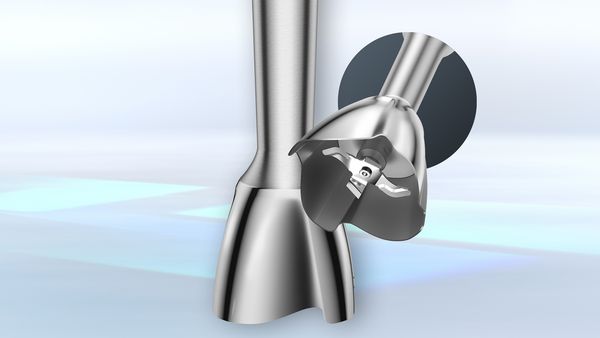 The base of one stainless steel blending shaft rests on a surface, while the blades are seen inside a second one.