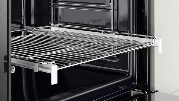 An open oven with extendable telescopic rails.