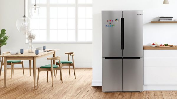 Modern white kitchen with Bosch fridge, hood, hob and Europe's Brand Nr. 1 award.