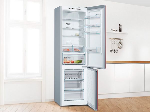 Built-in Bosch fridge freezer with open door to show food and drinks inside.