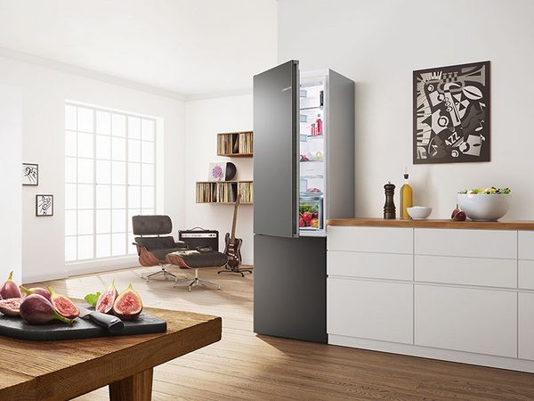Silver freestanding Bosch fridge-freezer in a white kitchen.