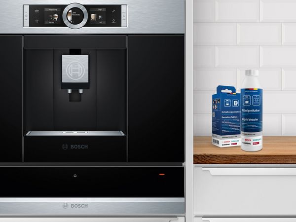 Built-in Bosch coffee machine and cleaning products on the side