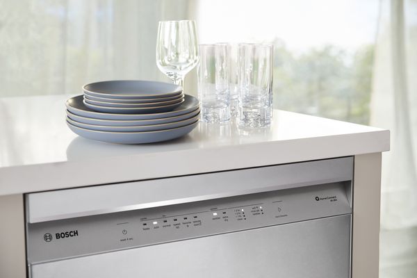 Bosch dishwashers with clean dishes on counter