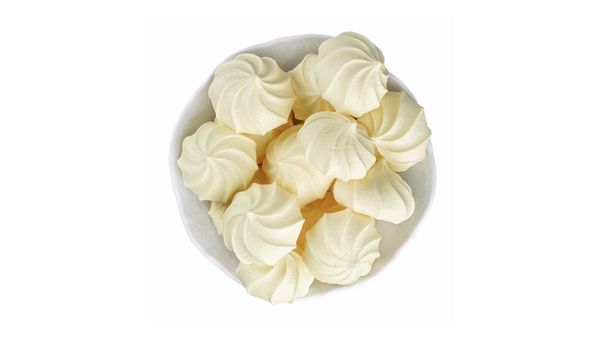 Selection of meringues in bowl shot from above.