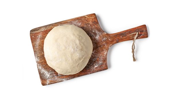 Dough ball on wooden board shot from above.