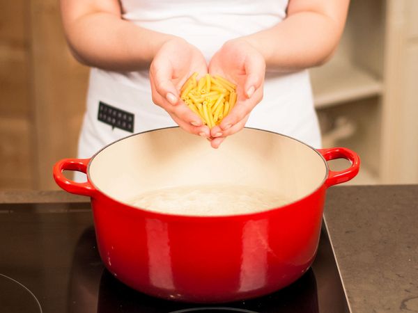 Adding macaroni to a bowl