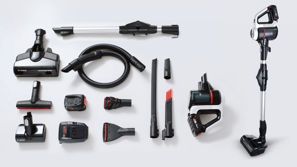 A disassembled cordless vacuum cleaner is laid out to show all the component parts as well as the range of accessories. The fully assembled model is seen on the right.