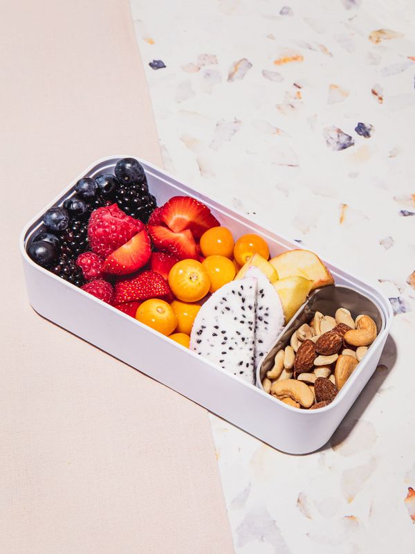 Bento bowl with fruits and nuts at an angle