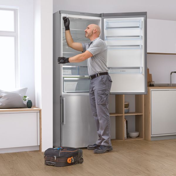 Bosch engineer servicing a fridge