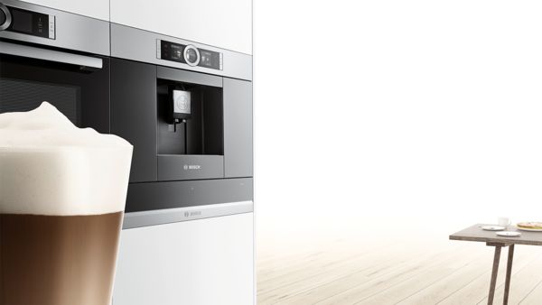 En kaffe står foran en Bosch kaffemaskin som er integrert i veggen.