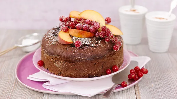 A delicious chocolate cake decorated with fresh fruit.