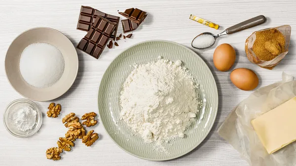 A view from above of baking ingredients on a kitchen table.