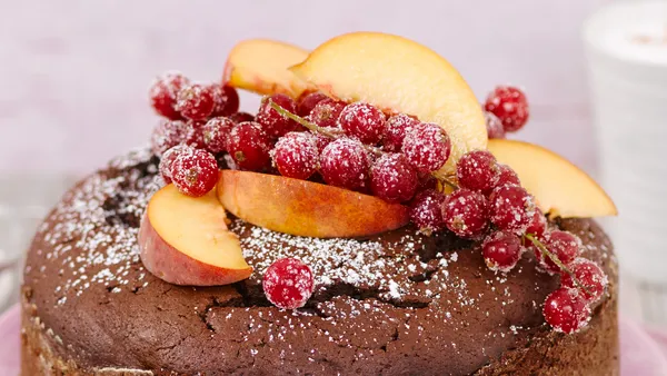 Close up of decorative fruit on a chocolate cake.