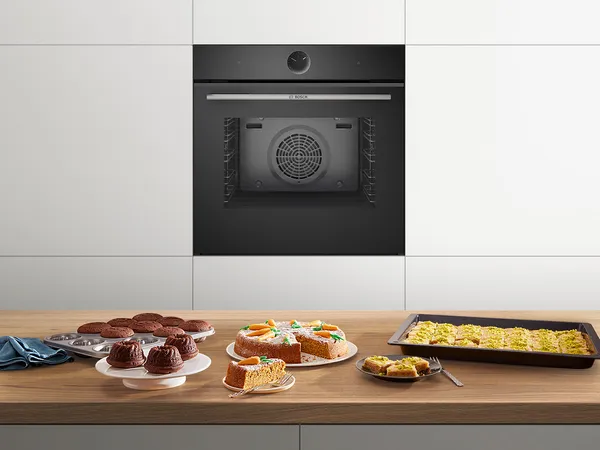 A kitchen island with freshly baked goods and an oven in the background.