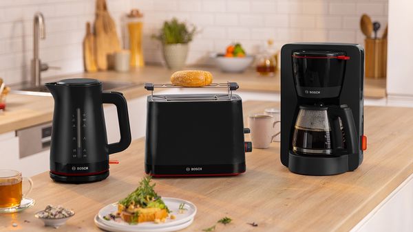MyMoment kettle, toaster and coffee machine in black on kitchen counter.