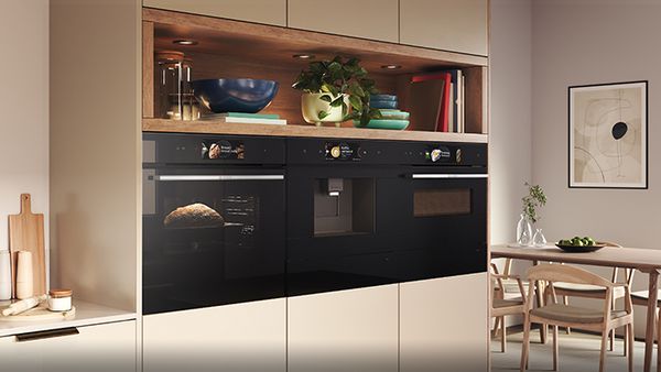 Kitchen setting with galley style oven placement in light wood cabinets