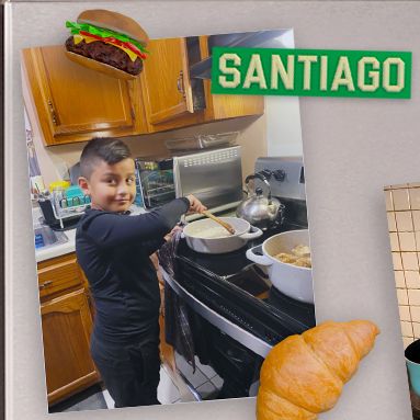 Santiago smiling at the camera while cooking.