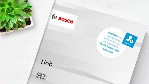 A Bosch oven manual on a white surface.