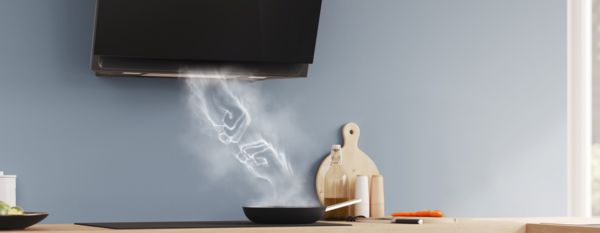The connection between the Inclined Hoods and Induction Hobs is symbolized by a fist bump of steam.