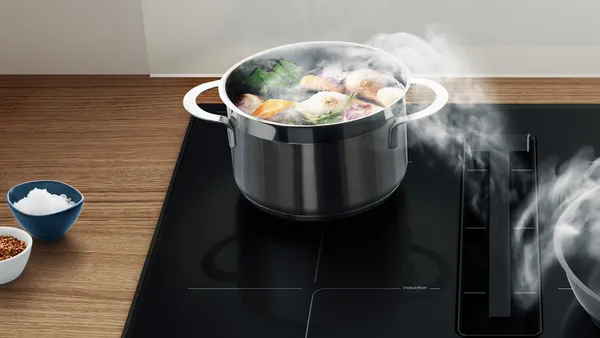 A venting hob extracting the steam from a pot.