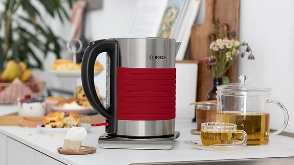 Silicone kettle on a kitchen top in red.