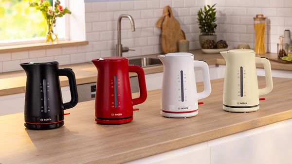MyMoment kettles on a kitchen top in black, red, white and cream.