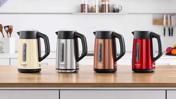 DesignLine kettles on a kitchen top in beige, stainless steel, copper and red.