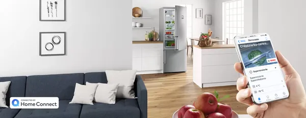 Aplikacja Home Connect pokazująca rekomendowany program prania – pralka i suszarka marki Bosch w tle.  