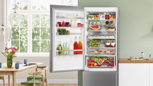 An open fridge freezer filled with food 