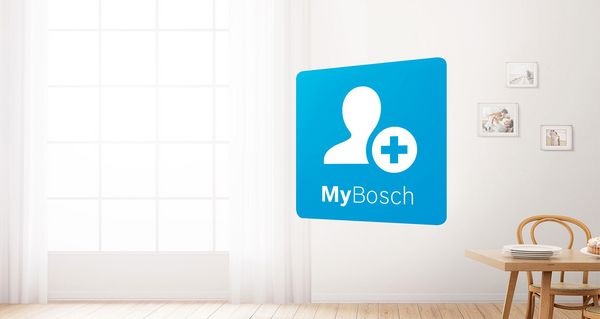 Планшет со значком MyBosch на переднем плане яркой кухни с бытовой техникой Bosch. Зеленый значок гарантии слева обозначает варианты расширенной гарантии.