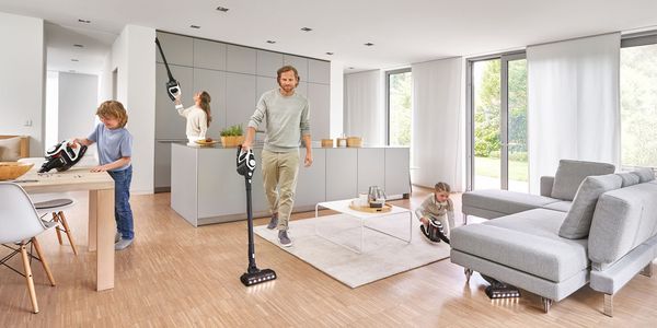 Multiple people using Unlimited vacuum cleaners in different ways and areas of living space