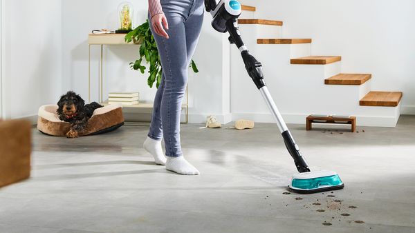 Person using Unlimited 7 Aqua to clean muddy paw prints