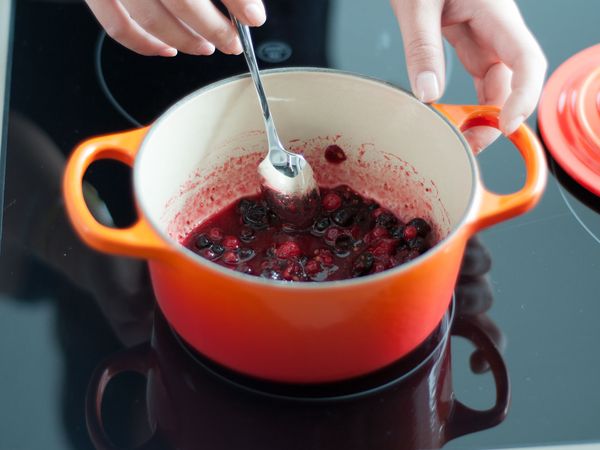 Melting berries in a pot on cooktop