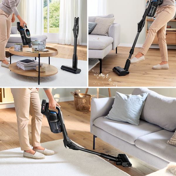 Giovane donna che utilizza in casa una scopa elettrica per le pulizie