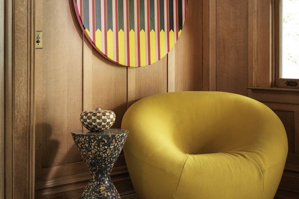 Yellow furnishings with wooden panelling in Chet Callahan’s house