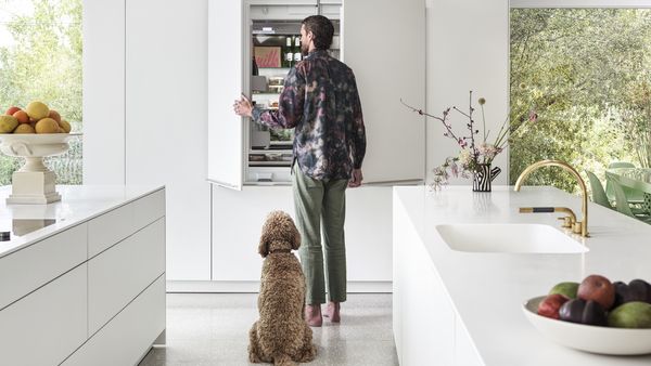 Chet and dog Lewie enjoy convenient access with a built-in Gaggenau refrigerator-freezer.