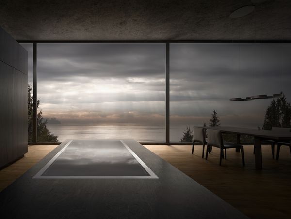 A Gaggenau 400 series induction cooktop in a minimalist kitchen with views over the sea. 