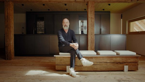 Helmut sits in front of his Gaggenau kitchen discussing the Black Forest House