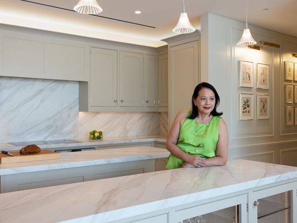 Portrait of Tammy standing in her kitchen fitted with Gaggenau appliances