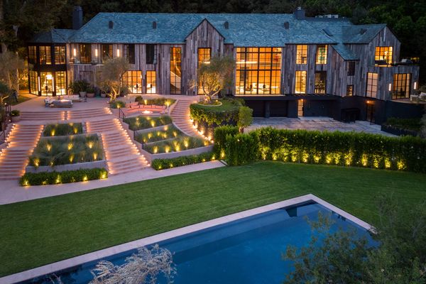 Aerial view at dusk across the swimming pool facing Max Noble’s Benedict Canyon Drive property in Beverly Hills