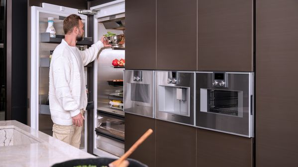 A candid photograph of Max using his Gaggenau kitchen