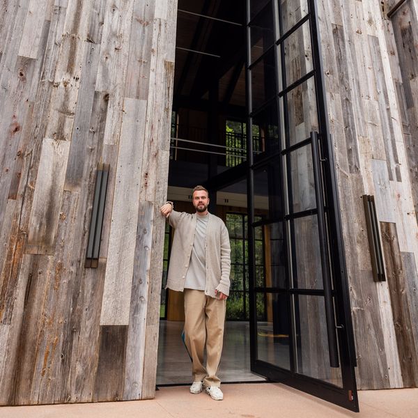 Candid photograph of Max standing in the aperture of the gigantic front door