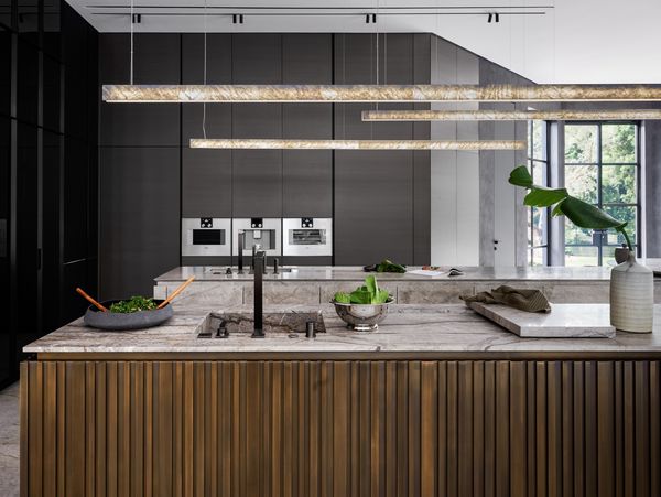 View across the kitchen island showing Gaggenau 400 series appliances